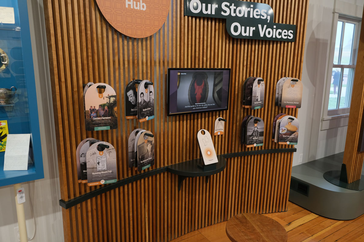 Graham Unruh interacting with the digital touchscreens on the exhibit columns.