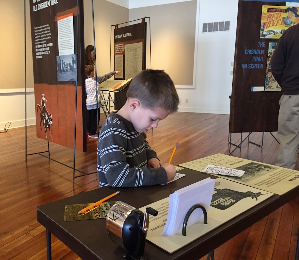 Visitor using Brand Your Beeves cattle branding stencil interactive