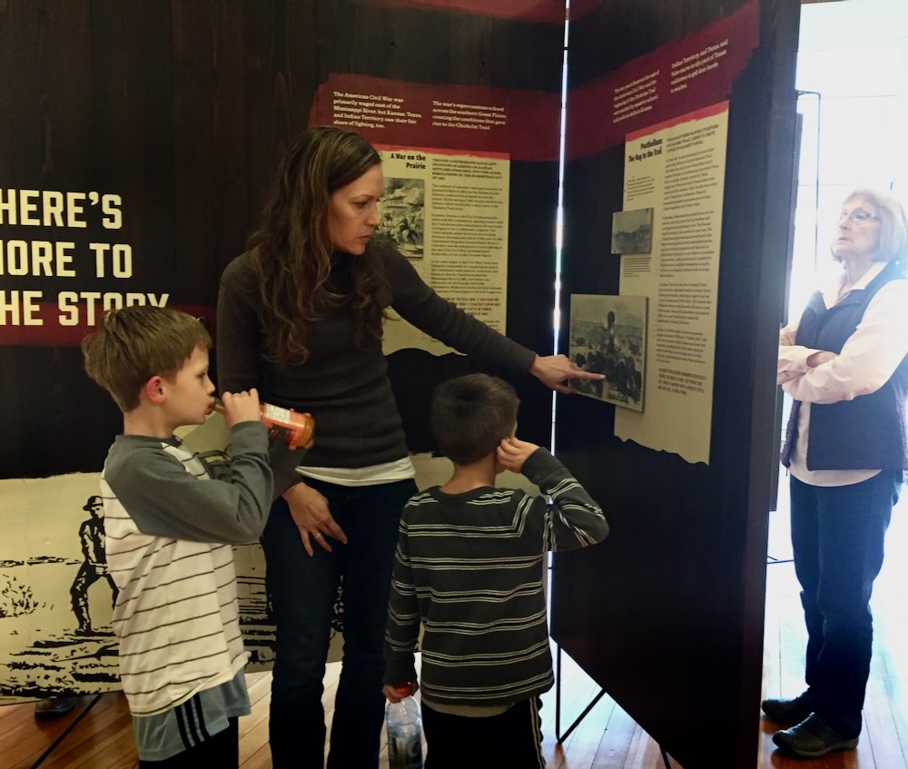 Layered painted panels on cedar wood and steel framework at Chisholm Trail exhibit