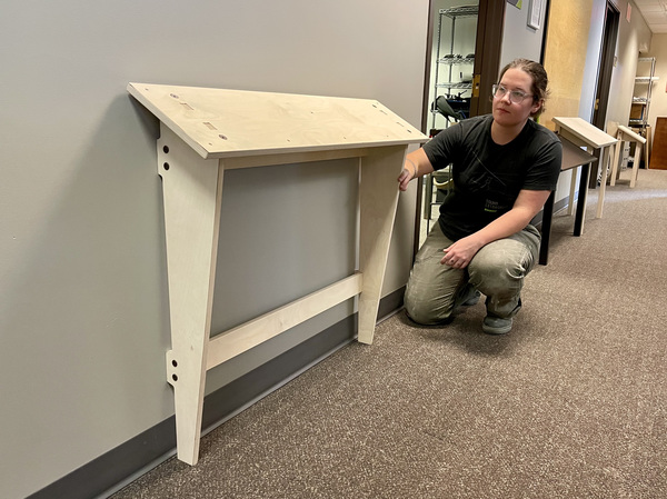 Jocelyn examining the Flat Pack Wall Mount Reader Rail prototype