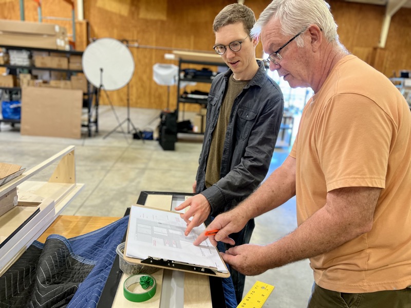 designer showing shop drawings to fabricator