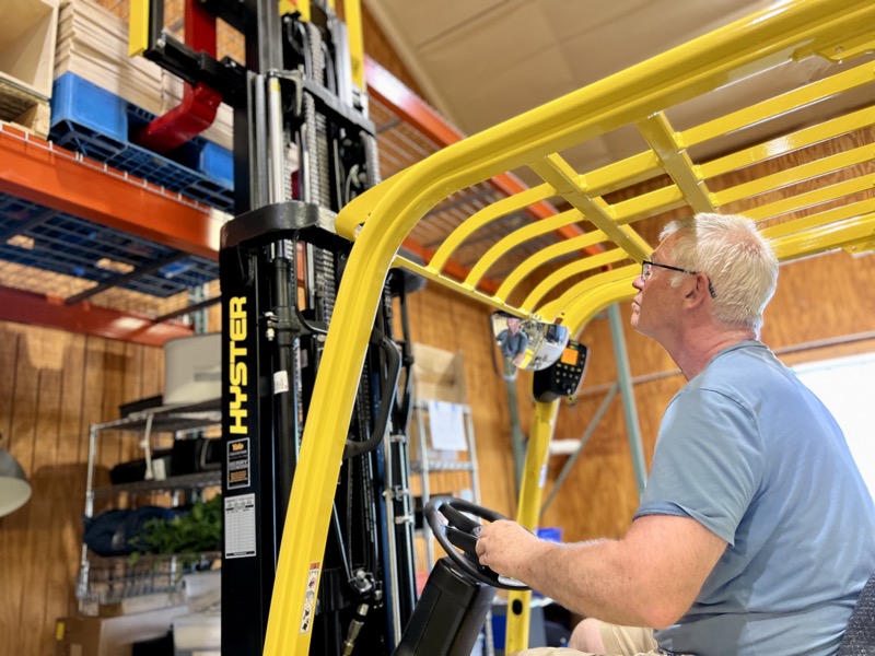 loading exhibits onto pallet racking with forklift