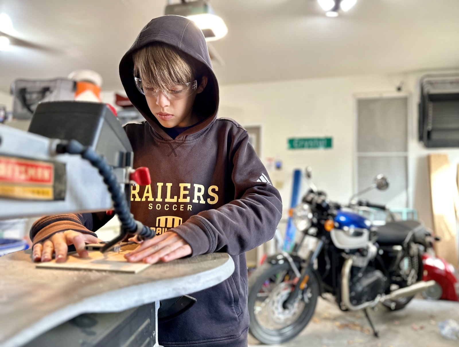 Brett making desk display with scrollsaw