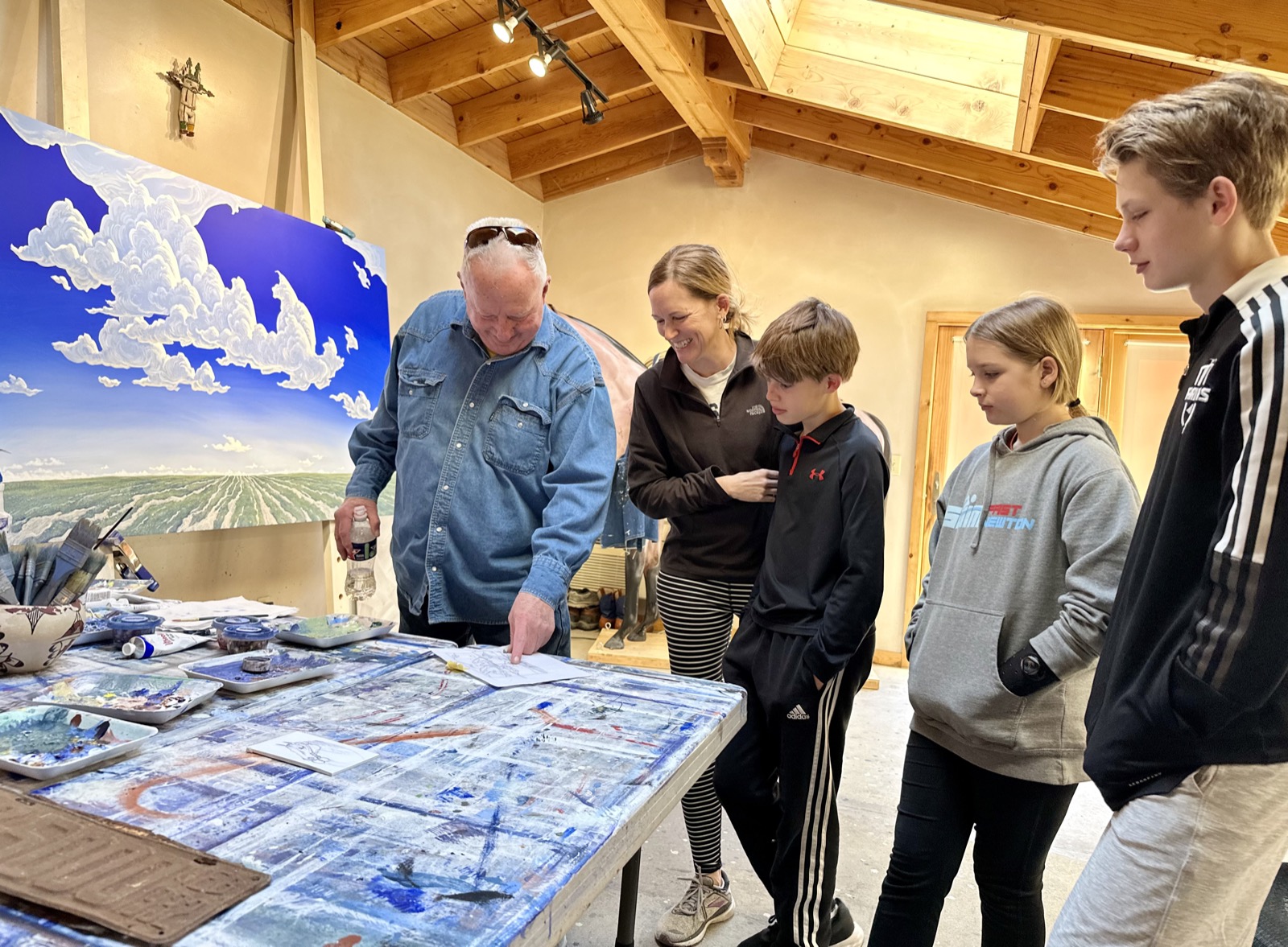 Phil Epp showing the Gaeddert Family his studio and process for Chisholm Trail painting